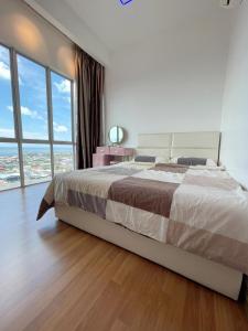 a bedroom with a large bed and a large window at Sekinchan Simple LoveSea House ~ Seaview 3-14AB in Sekincan