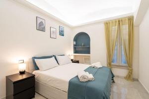 1 dormitorio con 1 cama con 2 toallas en San Lorenzo [10 min Colosseum taking M Manzoni] en Roma