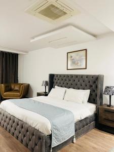 a bedroom with a large bed in a room at Luxury one bed Apartment in Gold Crest Mall And Residency DHA Lahore in Lahore