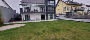 a large house with a lawn in front of it at Ferienwohnung am Ohmbachsee in Gries