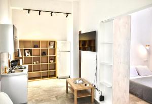 a small room with a bed and a table at Seaside Serenade 2 suite in Ermoupoli