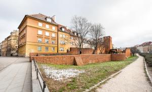 a brick wall in front of a building at Old Town 5-Bedroom Apartment in Warsaw