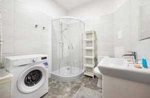 a bathroom with a washing machine and a sink at Old Town 5-Bedroom Apartment in Warsaw