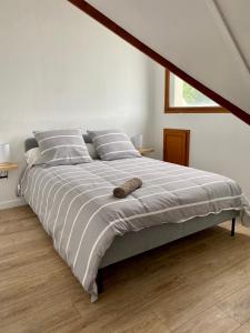 a bedroom with a large bed with two pillows at Welcome Home in Vert-le-Grand
