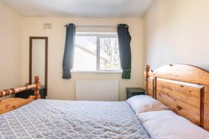 a bedroom with a wooden bed and a window at Twin bed in a quiet area in Dublin