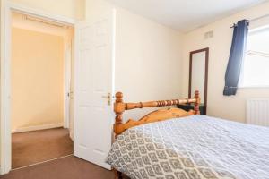 a bedroom with a wooden bed and a window at Twin bed in a quiet area in Dublin