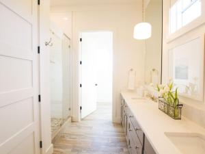 a bathroom with white counters and a sink and a mirror at Kaya Cottages in Dahlonega