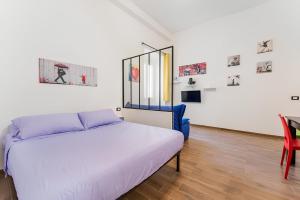 a bedroom with a bed and a table and a chair at CASA DI SILVIA a PORTA PIA in Rome