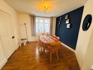 a dining room with a table and chairs at Chic 5 Bedroom House with Private Parking & Garden in Bristol