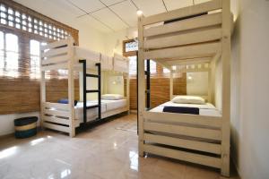 a bedroom with two bunk beds in a room at Plan B Coliving & Coworking in Weligama