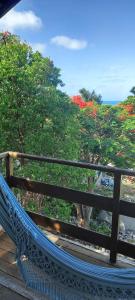 a hammock on a deck with a view of the ocean at Stay Cool Pipa in Pipa