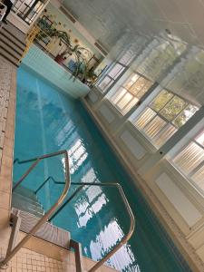 a swimming pool with a metal railing in a building at Studio Tonbachblick Baiersbronn in Baiersbronn