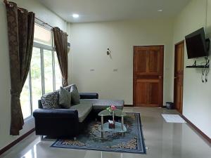 a living room with a couch and a table at Bang Yan Rimlay in Ko Yao Noi