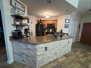 a kitchen with a stone island in the middle at Serenity on the Shores in Portage
