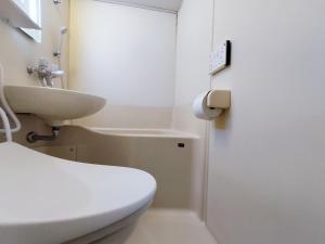 a bathroom with a white toilet and a sink at S21新宿最中心 東新宿站5分-Shinjuku center 5 mins to Station, Max 3P 直达新宿 涉谷 表参道 池袋 上野 代代木 银座 原宿 in Tokyo