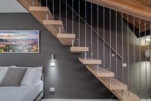 a bedroom with a staircase next to a bed at Forum Suites in Verona