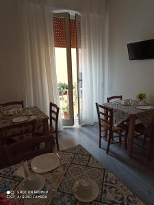 a dining room with tables and chairs and a window at B&B A Modo Mio in Marsala