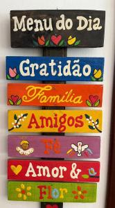 a group of colorful signs on a refrigerator at Pousada Sabor da Serra in Visconde De Maua
