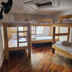 a room with four bunk beds in a room at Paisa Hostel Medellín in Medellín