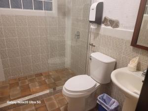 a bathroom with a toilet and a sink at LA CAPITANÍA RURAL, SAN PEDRO in Antigua Guatemala