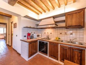 a kitchen with a sink and a stove top oven at Castello di Fulignano Soarzio panoramic apartment in San Gimignano +22 photos