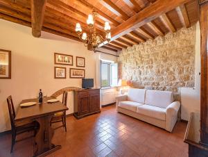 サン・ジミニャーノにあるSuperior apartment Soarzio Fulignano San Gimignanoのリビングルーム(ソファ、テーブル付)