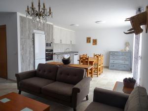 a kitchen and living room with a couch and a table at Casa Damajuana 