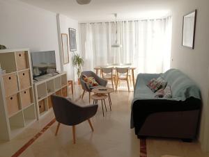 马拉加Piso Centrico 1.5km Playa con gran terraza +vistas的带沙发、椅子和桌子的客厅