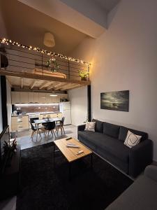 a living room with a couch and a table at Celeste Loft in Tríkala
