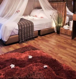 a bedroom with a bed and a red rug at Bintan Brzee Beach in Island Bintan - Bungalow 3 in Berakit