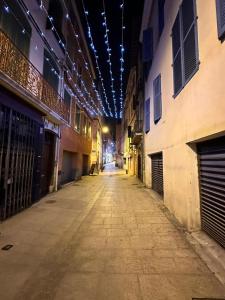 an empty alley with lights on the ceiling at Appartement T3 centre ville in Perpignan