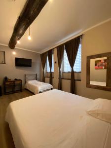 a bedroom with two beds and a flat screen tv at Piccolo Borgo in Chiavari