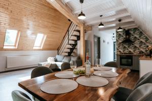 a dining room with a wooden table and chairs at Wild Cabin in Malaia
