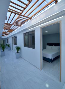 a bedroom with a bed in a white room at Casa Encanto Manga in Cartagena de Indias