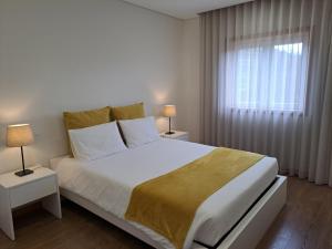 a white bedroom with a large bed and a window at Quinta da Portelada in Peso da Régua +53 photos