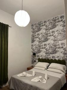 a bedroom with a large bed with a large wall at Les Artes in Rome