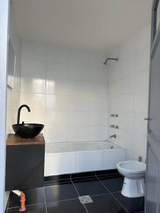 ein Badezimmer mit einer Badewanne, einem Waschbecken und einem WC in der Unterkunft ItaloPiano in Guaymallen