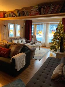 a living room with a christmas tree and a couch at KAB Guesthouse in Bogen