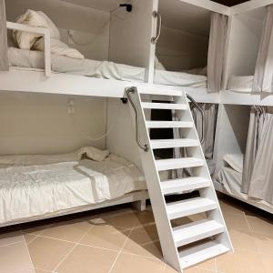 a white bunk bed with a ladder in a room at نجد هاوس - نساء فقط Ladies Hostel in Riyadh