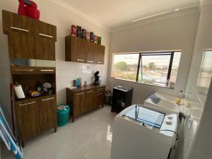 a small kitchen with a sink and a window at Apartamento Sorriso in Sorriso