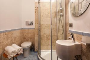 a bathroom with a shower and a toilet and a sink at Palazzo Giorgi in Siena +16 photos