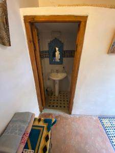 a small bathroom with a sink and a toilet at Dar Tetuania in Tetouan