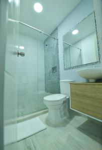 a bathroom with a shower and a toilet and a sink at Casa Encanto Manga in Cartagena de Indias