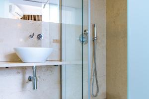 a bathroom with a sink and a shower at Hotel Londres Estoril / Cascais in Estoril