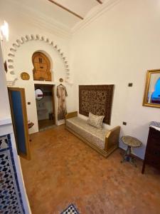 a living room with a bed and a table at Dar Tetuania in Tétouan