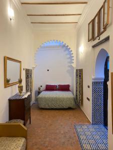 a bedroom with a bed and an archway at Dar Tetuania in Tetouan