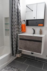 a bathroom with a sink and a tub and a mirror at Peaceful Villa in Los Angeles