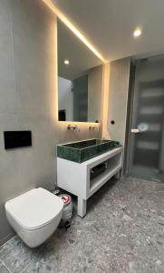 a bathroom with a toilet and a sink and a mirror at NEPTUNE OASIS Villa in Mythimna +53 photos