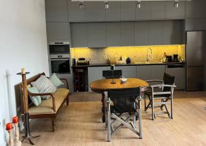 a kitchen with a table and chairs and a dining room at NEPTUNE OASIS Villa in Mythimna
