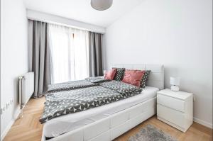 ein weißes Schlafzimmer mit einem großen Bett und einem Fenster in der Unterkunft Apartman Gold Oasis, self service check-in in Zagreb